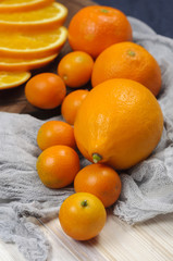 Fresh ripe citrus. Lemons, kumquat and oranges on wooden table