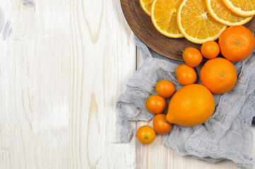 Fresh ripe citrus. Lemons, kumquat and oranges on wooden table