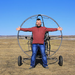 portrait of a man against the backdrop of a motor glider