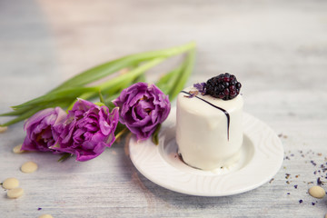 Cake with blackberry and tulip, Valentines Day background. Selective focus