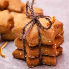 Homemade rye cookies star shaped stack tied with brown rope on baking paper