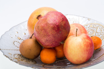 mix fresh fruits on plate isolated on white