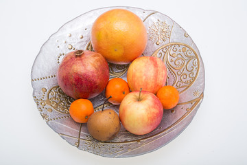mix fresh fruits on plate isolated on white