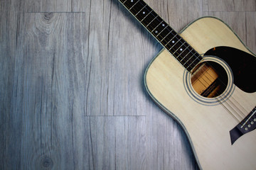 Obraz premium Acoustic guitar on wooden background