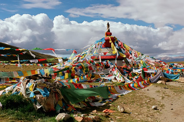Tibetan ritual stupa and prayer flags with mantras.