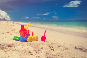 kid toys on tropical sand beach