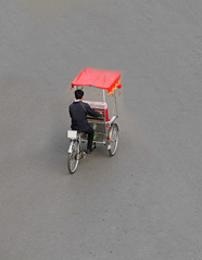 Unidentified cyclo rickshaw driver on a street in Hanoi capital, Vietnam.