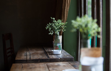 Spring flowers on the wooden table at a coffee shop, in door photo