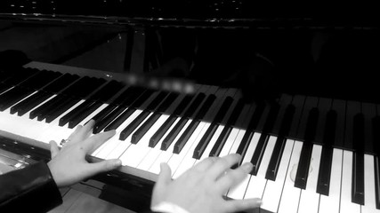 Hands of professional female musician playing melody on piano, retro effect