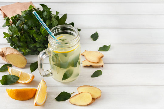Natural detox lemonade smoothie ingredients on white wood background