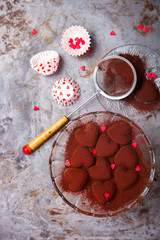 Chocolates in Heart-shaped glass Vase.Symbol Concept  Holiday Valentine's Day.top view. Copy space. selective focus.