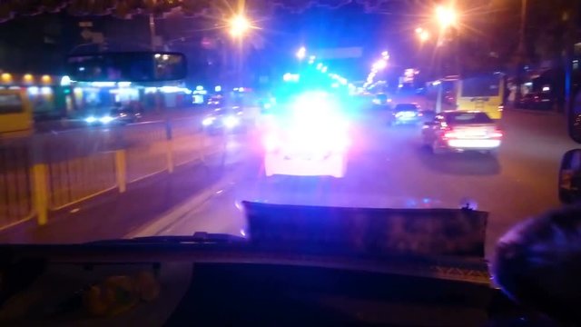 Police patrol car driving night city street, law enforcers on duty, public order