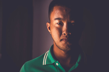 Portrait of Asia Man. Close up. Low key style.