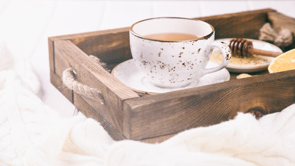 Cup of Ginger Tea with Lemon and Honey on a White Background.Concept Of Healthy Eating. Toned image.Vintage style.Copy space.  selective focus.