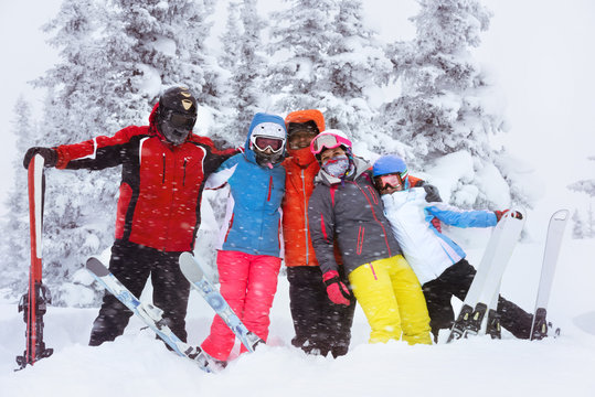 Happy adult friends skiers winter