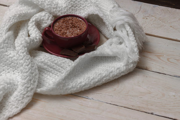 Milk chocolate in a cup on a saucer against a background of a sc
