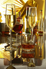 Glass of wine, brandy or cognac on the mirror wooden table