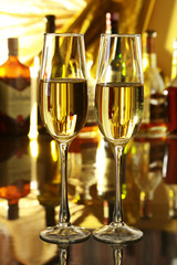 Glass of wine, brandy or cognac on the mirror wooden table