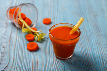 Freshly squeezed Carrot and celery juice in glass , on wooden background.Healthy food or diet concept.Copy space. selective focus.