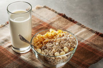Fresh muesli in a glass plate on the table with a napkin