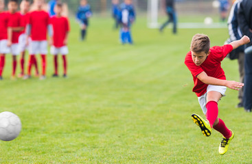 Boy kicking soccer ball