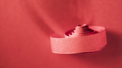 Macro, abstract, background picture of red paper spirals on paper background
