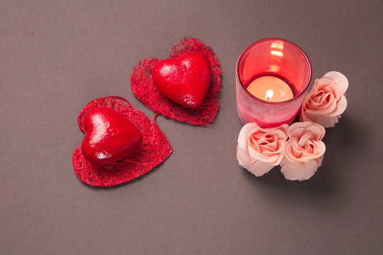 Valentines day background with two hearts roses and candle on gray background