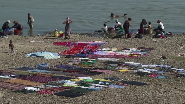 People washing clothes in te river, Mandalay, Myanmar
