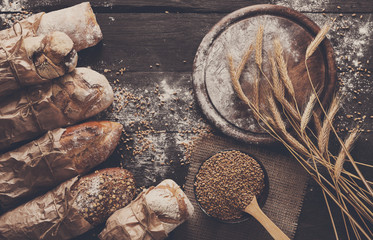 Bread bakery background. Brown and white wheat grain loaves composition
