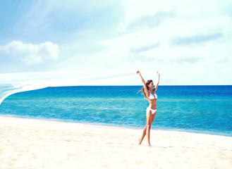 Fototapeta na wymiar Young and beautiful girl in white swim suit posing on beach. Tra