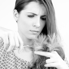 Woman cutting split ends hair
