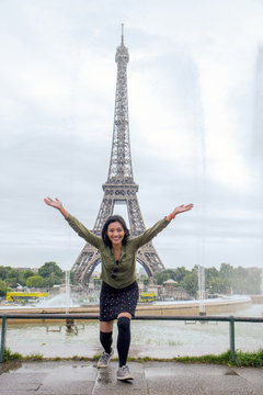 cheerful woman under water of fountain at the Eiffel Tower