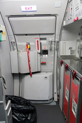 emergency exit door with kitchen in airplane © milkovasa