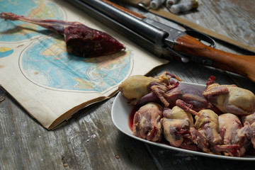 Hunting equipment and hunting trophies on old wooden background