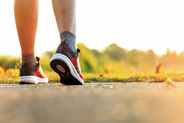 closeup women running at lakeside jogging with warm fall colors