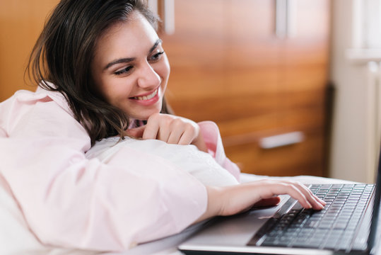 Laptop typing in bed