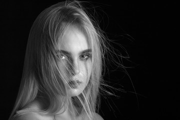 beautiful girl portrait with flying blond hair monochrome