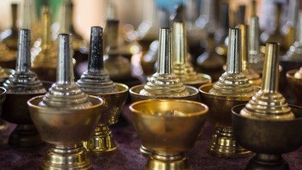 to pour water slowly onto the ground or a vessel,so that the dead might benefit from merit making.