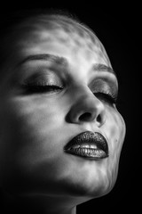 happy luxury woman model with professional makeup on black background monochrome