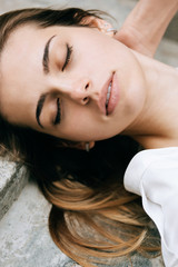 Outdoors portrait of beautiful young sensual woman with eyes closed. sleep concept