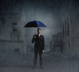 Businessman with umbrella. Black background with copyspace. Busi