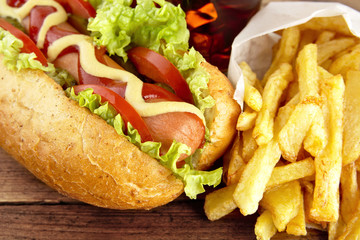 Hotdogs ready-to-eat with fresh salad on wooden desk
