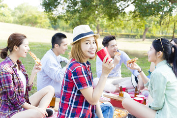 happy young friends enjoying  healthy picnic