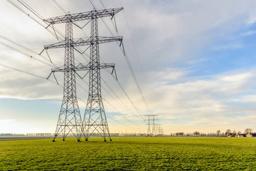 Row of power pylons in a rural Dutch landscape