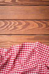 Red folded tablecloth on wooden table