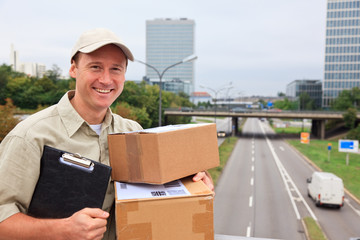 Delivery Boy Standing On A Bridge