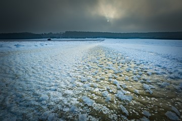 Frozen water reservoir on fields. Winter landscape.