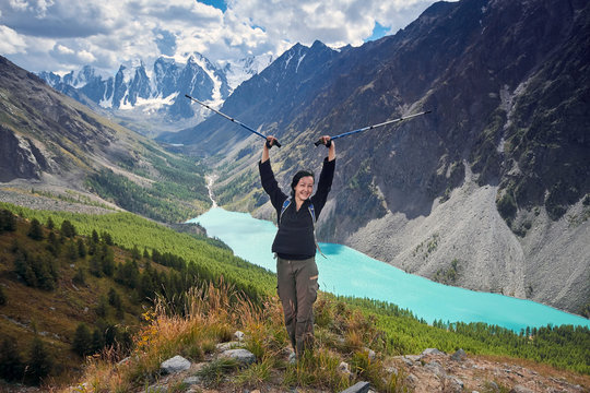 Brave Girl Conquering Mountain Peaks Of The Altai Mountains. The Majestic Nature Of The Mountain Peaks And Lakes. Hiking In Rugged Places. Journey Through Russia, Siberia, Aktru And Shavlinskoe Lake