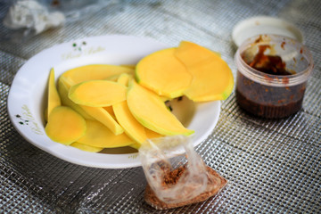Yellow slice of  mango and sweet sauce ,tropical fruits