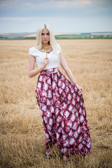 Fototapeta na wymiar Blonde in a wheat field